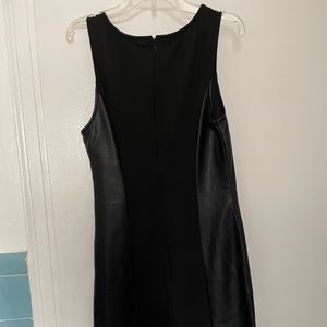 Black tank dress with figure flattering faux leather sides inserts. Size small